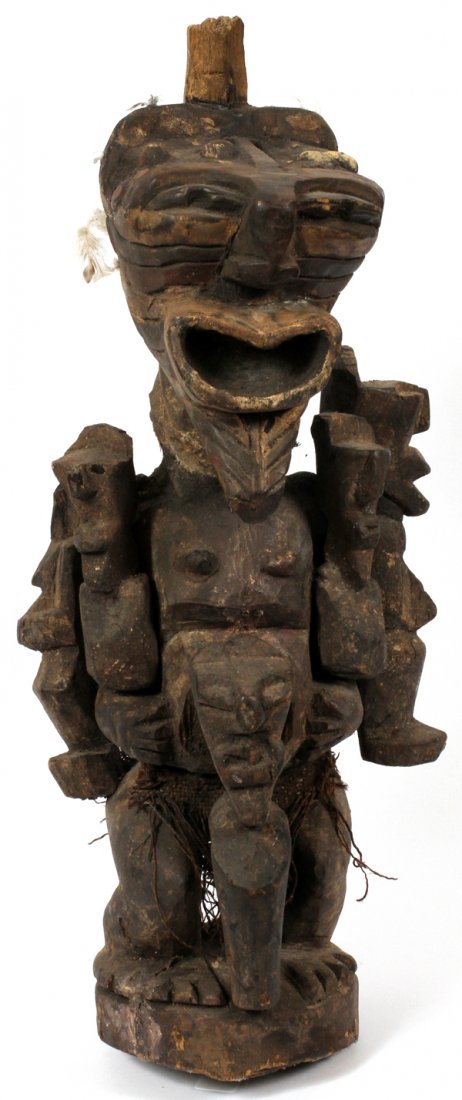 AFRICAN SONGYE CARVED STATUE: AFRICAN SONGYE CARVED STATUE, H 28": From the Songye tribe, Democratic of the Congo. In a crouched position, having hands rested on a protruding stomach, surrounded by raised figures at the base. The 