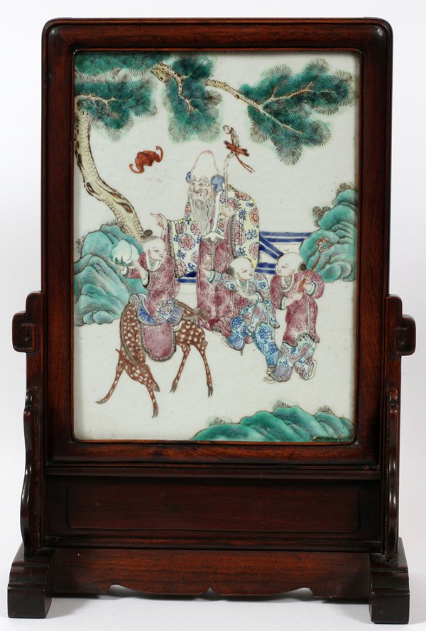 CHINESE HAND-PAINTED PORCELAIN TABLE SCREEN: CHINESE HAND-PAINTED PORCELAIN TABLE SCREEN, ANTIQUE, H 21'', W 14'':Presented in a mahogany stand. Depicting two children walking with their elder, one is riding a deer.