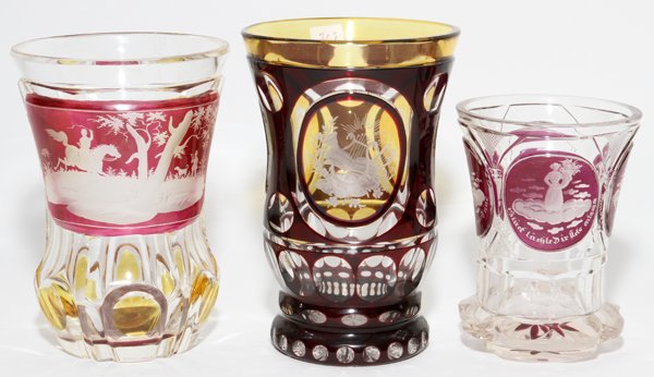 BOHEMIAN CRYSTAL BEAKERS 3 PIECES-5 1/2: BOHEMIAN CRYSTAL BEAKERS, 3 PIECES, H 4 1/4"-5 1/2": Includes one with ruby overlay and etched reserves, and two with cranberry and topaz overlay reserves, one depicts a hunt scene, the other with fig