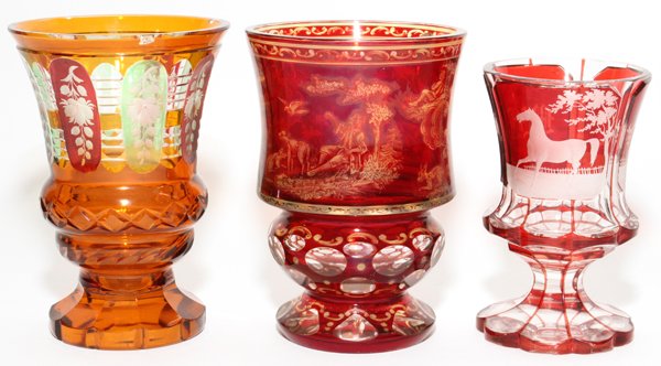 BOHEMIAN CRYSTAL OVERLAY BEAKERS C. 1900, 3: BOHEMIAN CRYSTAL OVERLAY BEAKERS, C. 1900, 3 PIECES, H 5"-5 3/4":Including two ruby overlay, one of which with monogram, the other pastoral motifs, and one with amber overlay.