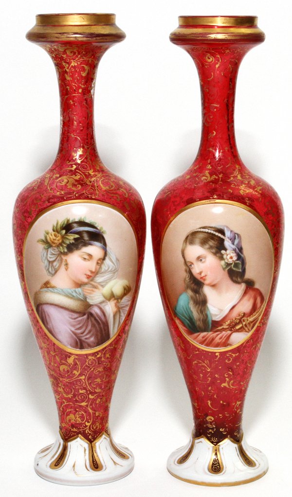 BOHEMIAN ENAMELED CRANBERRY GLASS PORTRAIT VASES: BOHEMIAN ENAMELED CRANBERRY GLASS PORTRAIT VASES, C. 1880, PAIR, H 10 1/2":Each has a hand painted oval portrait reserve at one side, floral sprays on the reverse, with fired gold scrolls on the cranb