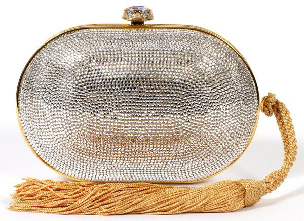 JUDITH LEIBER SILVER MINAUDIERE W/ GOLD TASSEL: JUDITH LEIBER SILVER MINAUDIERE WITH GOLD TASSEL, W 8": Oval shape with crystals overall, oval crystal and enamel push button opening to gold leather lining. Stamped: Judith Leiber, New York. Measures