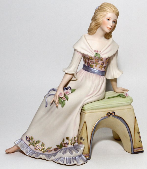 CYBIS BISQUE FIGURE OF SEATED GIRL #83: CYBIS BISQUE FIGURE OF SEATED GIRL, #83, H 8 1/2":Depicting seated girl with flowers, measuring H. 8 1/2" x 7 1/2". Signed and numbered at underside.