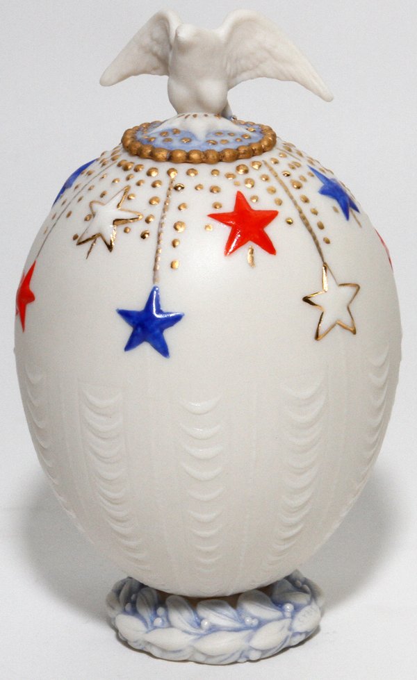 CYBIS BISQUE LIDDED EGG JAR: CYBIS BISQUE LIDDED EGG JAR, H 5 1/4":Raised on a pedestal base, with eagle form finial. Signed at underside.