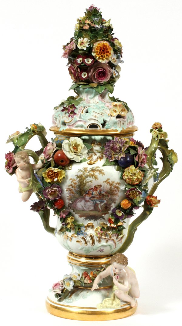 MEISSEN PORCELAIN COVERED URN C. 1900: MEISSEN PORCELAIN COVERED URN, C. 1900, H 26", W 14":A hand painted courting scene at one side and a floral spray on the reverse, flanked by stem handles with applied putti and flowers, the cover cent