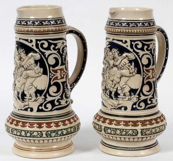 GERMAN EARTHENWARE BEER PITCHERS TWO: GERMAN EARTHENWARE BEER PITCHERS, TWO, H 11 1/2":Two liter size, tavern scenes. Circa 1900 - 20.