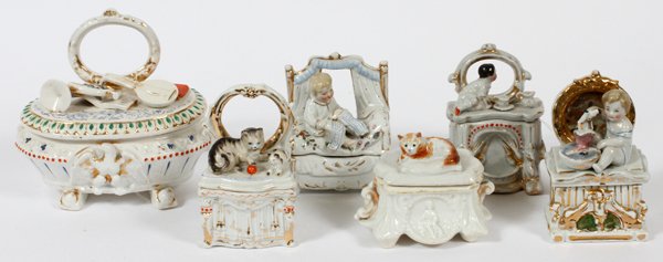 GERMAN PORCELAIN FIGURAL TRINKET BOXES C. 1850: GERMAN PORCELAIN FIGURAL TRINKET BOXES, C. 1850, SIX, H 2 1/2"-5 1/2":Including 3 with a child at the cover, one of which is bathing a doll, 2 have cats, and 1 with musical instruments; several marked
