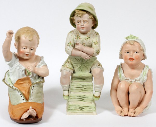 GERMAN BISQUE PIANO BABIES THREE: GERMAN BISQUE PIANO BABIES, THREE, H 11"-15":Hand painted. Circa 1900