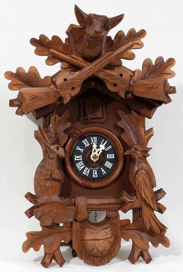 GERMAN CARVED WOOD CUCKOO CLOCK: GERMAN CARVED WOOD CUCKOO CLOCK, H 14 1/2", W 9":Marked "Made in Germany".