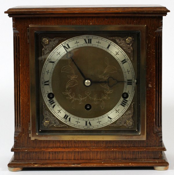 ELLIOT LONDON OAK CASE MANTEL CLOCK: ELLIOT LONDON, OAK CASE MANTEL CLOCK, H 9", W 9", D 5":HAND CHASED DESIGN. SILENT CHIME. MADE IN ENGLAND. #5430 NOTED ON BOTTOM OF WOOD CASE.