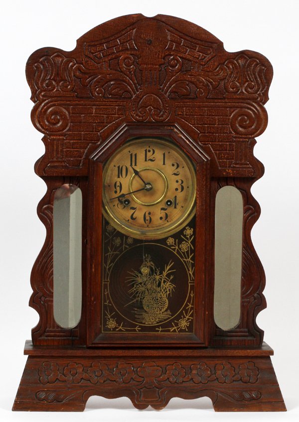 NEW HAVEN CARVED WOOD MANTEL CLOCK: NEW HAVEN CARVED WOOD MANTEL CLOCK, H 24", L 17":Carving to the entire clock with mirrors flanking the clock. Floral designs to the glass door and having a two key wind.