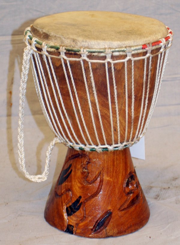 AFRICAN CARVED WOOD & ANIMAL HIDE DRUM: AFRICAN CARVED WOOD & ANIMAL HIDE DRUM, H 16", W 16":Having tied rope at the top with strap, decorated in carved abstract forms on base. Measures H. 16" x 16".