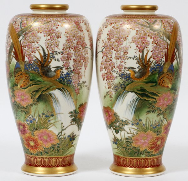 JAPANESE SATSUMA EARTHENWARE VASES PAIR: JAPANESE SATSUMA EARTHENWARE VASES, PAIR, H 9 3/4":Decorated in waterfall landscape scenes, with birds and flowers; finely detailed in gilt. Both signed at underside.