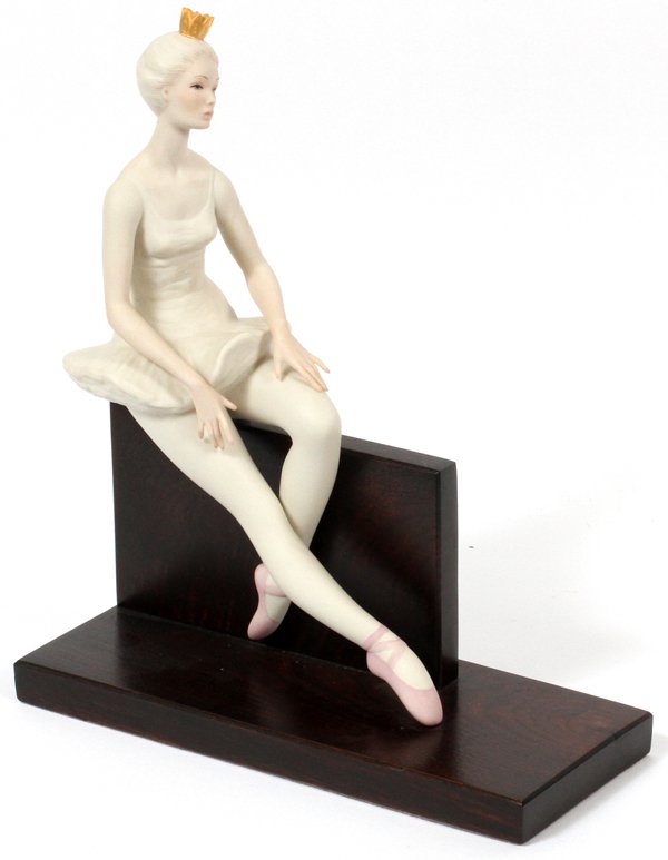 CYBIS BISQUE FIGURE OF BALLERINA: CYBIS BISQUE FIGURE OF BALLERINA, H 13", W 11":Depicting figure of a seated ballerina, on wood stand. Signed at underside. Measures H.13" x 11".