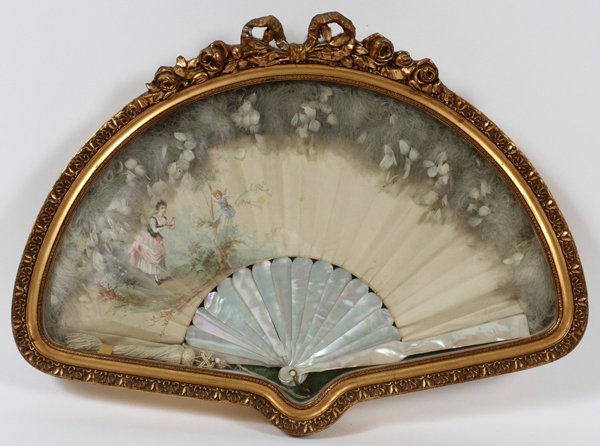 EUG JACOB HAND PAINTED SILK MOTHER-OF-PEARL FAN: EUG. JACOB, HAND PAINTED SILK & MOTHER-OF-PEARL FAN, H 11", W 19":Woman with cupid; signed lower left; gilt carved wood shadowbox frame with bowknot and rose crest.