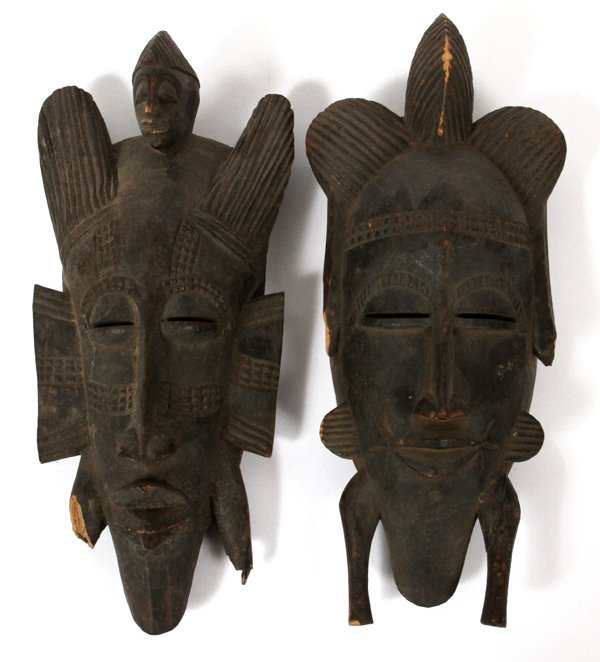 AFRICAN SENUFO TRIBE KPELIE TRIBAL MASKS 2 PCS: AFRICAN SENUFO TRIBE, KPELIE TRIBAL MASKS, 2 PCS, H 12'':Both are of hollow oval forms, with linear incised detailing to the hair and raised sides, which surround the face. Both faces have oval slit e