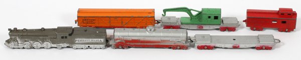METAL MINIATURE TRAINS SIX: METAL MINIATURE TRAINS, SIX L 4 1/2":Tootsie Toy miniature train, including: Pennsylvania steam locomotive and tender, tank car, flat car, box car, crane car and caboose.