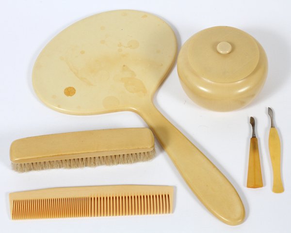 BAKELITE DRESSER SET 6 PCS: BAKELITE DRESSER SET, 6 PCS:includes on hand mirror, hair brush, comb, covered hair receptacle and two manicure tools.