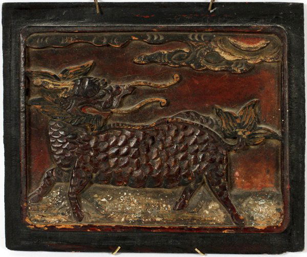CHINESE CARVED POLYCHROME RELIEF SCULPTURE: CHINESE CARVED POLYCHROME RELIEF SCULPTURE, H 8" W 9 1/2":Having a dragon carved in bas-relief. Decorated with red pigment, framed in a black border.