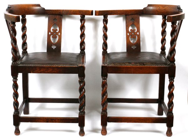 CARVED OAK & LEATHER CORNER CHAIRS PAIR: CARVED OAK & LEATHER CORNER CHAIRS, PAIR, H 30":Raised on barley twist, straight legs, with a lower stretcher; having curved form arms, with pierce carved double back splats, and inset leather seats.