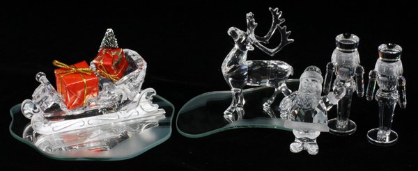 SWAROVSKI CRYSTAL CHRISTMAS MINIATURES FIVE: SWAROVSKI CRYSTAL CHRISTMAS MINIATURES, FIVE, H 3": Including 1 sleigh, L.4 1/4", with wrapped presents, on a mirrored base, 1 reindeer, H.3 1/4", on a mirrored base, 1 Santa Claus, H.2 1/2", and 2 nu