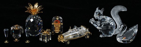 SWAROVSKI CRYSTAL MINIATURES NINE: SWAROVSKI CRYSTAL MINIATURES, NINE, H 1"-2":Including 1 "Celebrations" champagne bucket with 2 flutes, 1 pineapple, H.2 1/4", 1 wrapped present, H.7/8", 1 juke box, 1 "Journeys" vintage car, L.2 3/4",