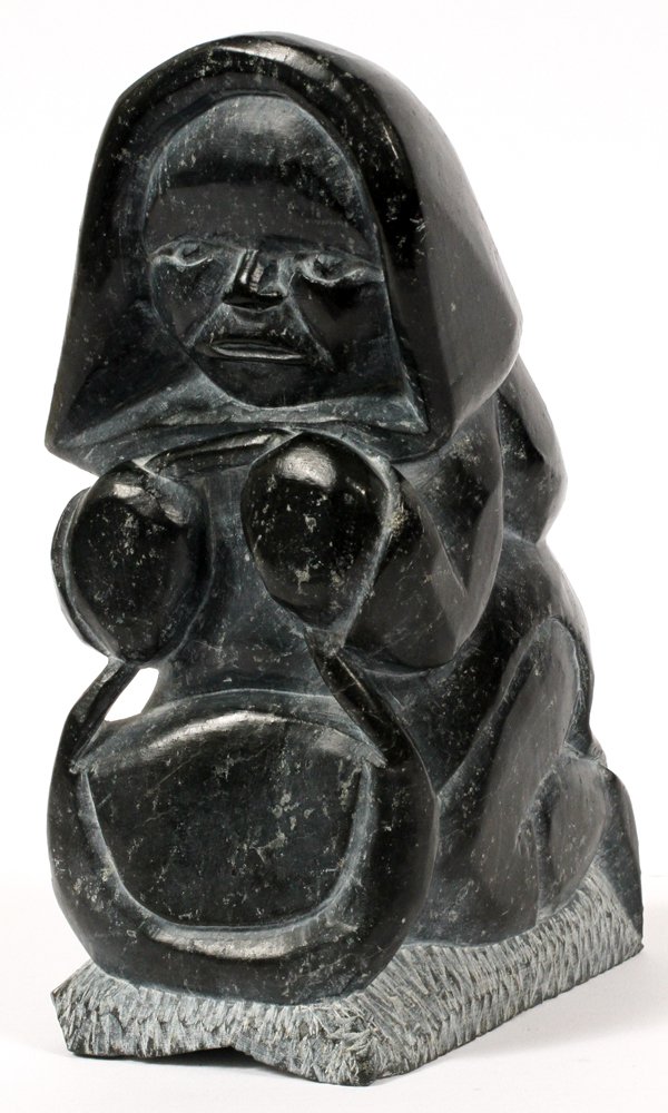 INUIT STONE SCULPTURE: INUIT STONE SCULPTURE, H 7", W 2 3/4":Stone carving of an Eskimo figure. Measures H. 7" x 2 3/4" x 3 1/2". Probably Canadian. #E91735