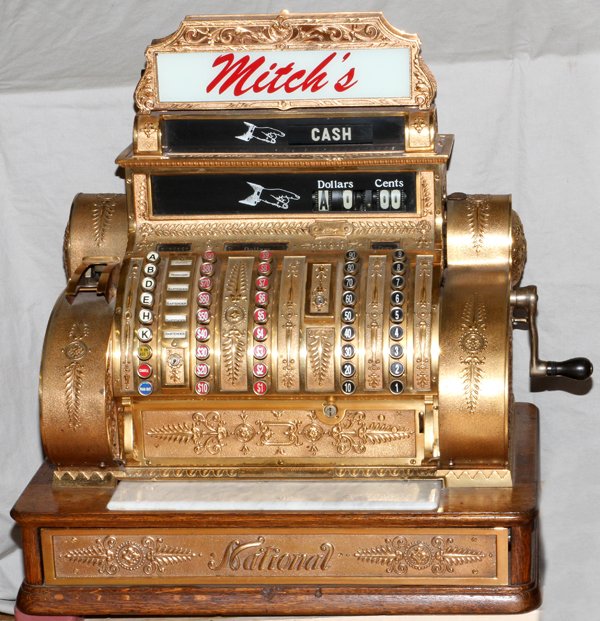 NATIONAL MODEL 452-E SOLID BRASS CASH REGISTER: NATIONAL, MODEL 452-E, SOLID BRASS CASH REGISTER, H 27", L 25", D 16.5":Ex. Mitch's Bar Grand River Ave. Detroit, MI. Solid brass on an oak base with serial number 1270567.
