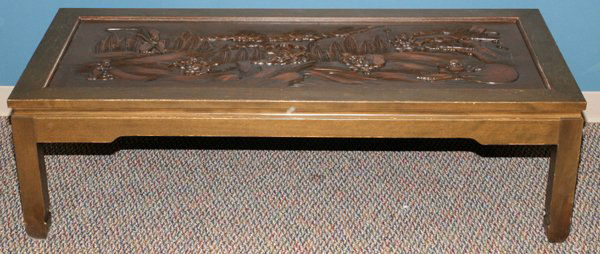 CHINESE CARVED COFFEE TABLE: CHINESE CARVED COFFEE TABLE, H 16", W 54", D 24":depicts farming scene on the top in relief. Includes one piece glass top.