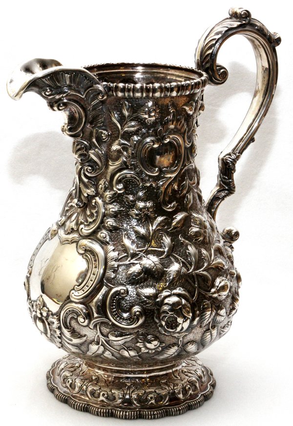 GALE & WILLIS COIN SILVER WATER PITCHER C. 1860: GALE & WILLIS COIN SILVER WATER PITCHER, C. 1860, H 11 1/2", RETAILED BY TIFFANY & CO.:Baluster-form with repousse floral and scroll pattern overall, stamped "1920, Tiffany & Co., G & W, 4" at the und