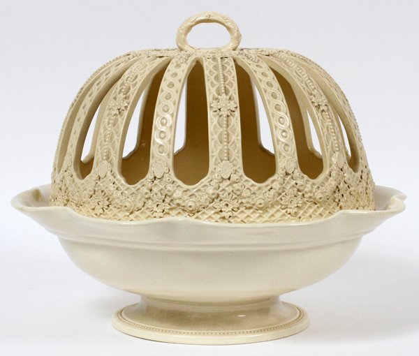 WEDGWOOD CREAMWARE CITRUS BOWL W/ COVER 19TH C.: WEDGWOOD CREAMWARE CITRUS BOWL WITH COVER, 19TH C., H 10", DIA 11":A round bowl with ruffled rim surmounted by a pierced cover with leaf and floral motif decoration. Impressed "Wedgwood" only (see add