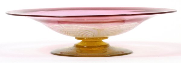 AMBERINA GLASS FOOTED SHALLOW BOWL: AMBERINA GLASS FOOTED SHALLOW BOWL, DIA 7 3/4":Decorated with an opalescent pulled flower form at center. Measuring H. 2" x 7 3/4". No apparent markings.