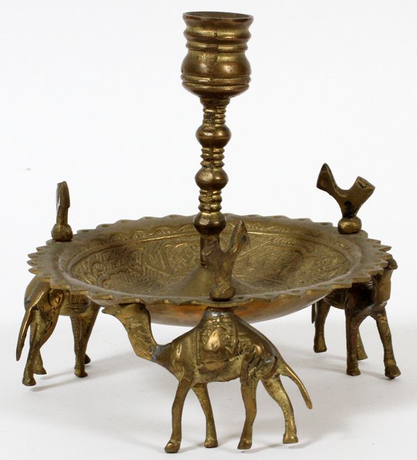 SAUDI ARABIA BRASS CANDLE HOLDER C. 1900: SAUDI ARABIA BRASS CANDLE HOLDER, C. 1900, H 5", W 5":Three camel form feet that are attached by threaded screws and hand made wing nuts, Arabic calligraphy in border. 1900 or earlier.