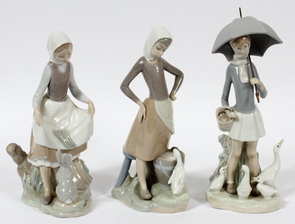 LLADRO PORCELAIN FIGURES THREE: LLADRO PORCELAIN FIGURES, THREE, H 9"-10":Including "Girl Feeding Rabbit", number 4826, "Girl with Milk Pail", number 4682, and "Girl with Parasol and Geese", number 4510.