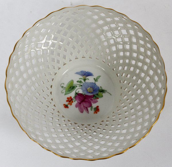 KPM PORCELAIN BASKET FORM DISH 20TH C.: KPM PORCELAIN BASKET FORM DISH, 20TH C., DIA 5 1/2":Round dish, with scalloped edges lined in gilt, and pierced basket form sides. Decorated with floral bouquet at the center. Marked at underside, #60