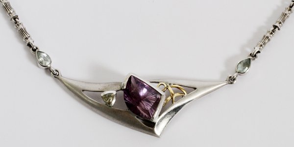 STERLING & GOLD AMETHYST NECKLACE: STERLING & GOLD AMETHYST NECKLACE, L 17":Sterling and 18kt gold necklace, featuring an amethyst stone in an Arabian style setting. Measuring L. 17", with a total approximate weight of 0.93 tr.oz. or 3
