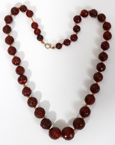 COSTUME CARVED GLASS BEAD NECKLACE: COSTUME CARVED GLASS BEAD NECKLACE, L 17 1/2":Graduated bead necklace, carved in foliate and line design. Measuring L. 17 1/2".