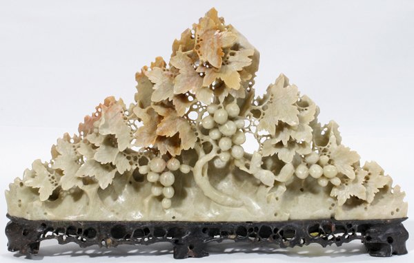 CHINESE CARVED SOAPSTONE GRAPES ON A VINE: CHINESE CARVED SOAPSTONE GRAPES ON A VINE, EARLY 20TH C., H 7", W 12":Light green color with brown accents, triangular shape consisting of grapes and vines. Soapstone base.