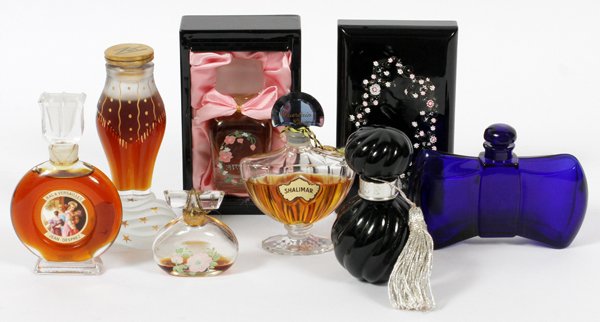 FRENCH CRYSTAL PERFUME BOTTLES SEVEN: FRENCH CRYSTAL PERFUME BOTTLES, SEVEN, H 3"-5", INCLUDING BACCARAT & 'ZUT' BY SCHIAPARELLI:Including 1 Baccarat cobalt blue perfume bottle for Guerlain, in the shape of a bow, H.3", W.4"; 1 Schiaparel