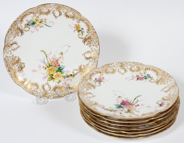 SARREGUEMINES PORCELAIN DESSERT PLATES C. 1910 - 8: SARREGUEMINES PORCELAIN DESSERT PLATES, C. 1910, SET OF EIGHT, DIA 7 1/2":Having fired gold scrolling foliate borders on a white ground, decorated with multi color floral sprays. Marked at underside w