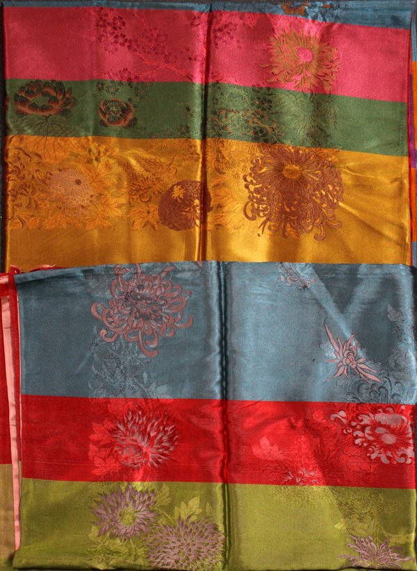 CHINESE SILK TABLECLOTHS TWO: CHINESE SILK TABLECLOTHS, TWO, 76" X 52":Floral Pattern. - One Has a Cranberry Color with Birds. / One Has a ' Peach Color with Floral Crystimums. Both are the same size.