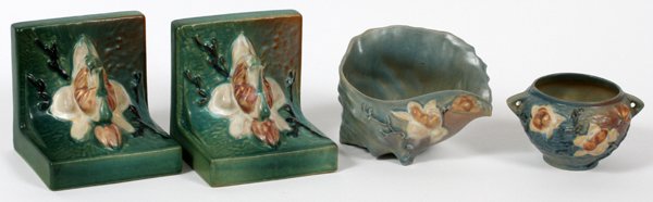 ROSEVILLE 'MAGNOLIA' VESSELS & BOOKENDS FOUR: ROSEVILLE 'MAGNOLIA' VESSELS & BOOKENDS, FOUR, H 3"-5 1/4":Including a pair of "Magnolia" bookends, measuring H. 5 1/4" x 5"; together with one vase, and one conch shell, #453-6, measuring H. 3 1/4" x