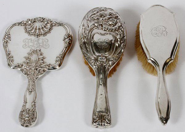 STERLING SILVER HAND MIRROR & BRUSHES EARLY 20TH C.: STERLING SILVER HAND MIRROR & BRUSHES, EARLY 20TH C., THREE, L 10":Including two English Birmingham Sterling hair brushes, one of which is by William Aitken, circa 1904; together with one Sterling han