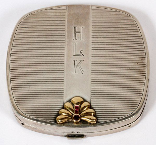 ART DECO STERLING & RUBY COMPACT: ART DECO STERLING & RUBY COMPACT, W 2 7/8":A sterling silver compact, square shape with rounded corners, the hinged cover is monogrammed HLK, inset rubies accent the yellow gold flourish (not marked),
