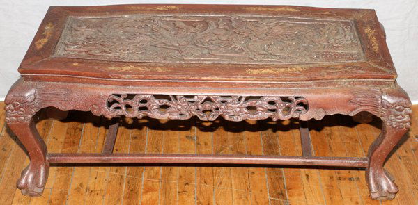 CHINESE CARVED WOOD COFFEE TABLE: CHINESE CARVED WOOD COFFEE TABLE, H 18", L 46":Carved in high relief with central dragon and Phoenix bird designs, claw feet and mother of pearl accents around the border. Measures H.18" x 46" x 21".