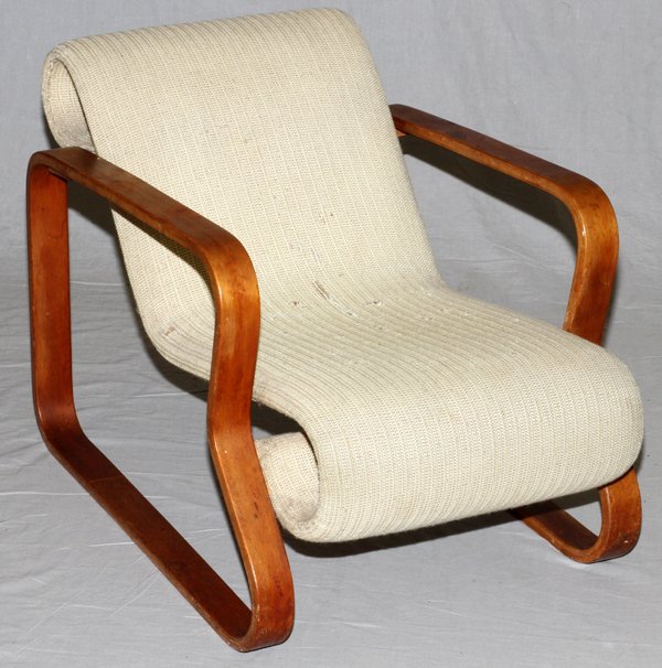ALVAR AALTO STYLE LOUNGE CHAIR C. 1940-1960: ALVAR AALTO STYLE LOUNGE CHAIR, C. 1940-1960, H 24", D 38":Laminated wood lounge chair, in the style of Alvar Aalto. Upholstered in cream, measuring H. 24" x 38". Unmarked. Circa 1940 to 1960.