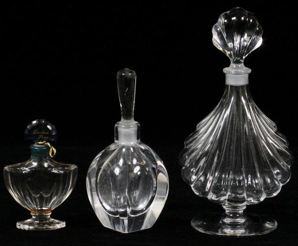BACCARAT & ORREFORS CRYSTAL PERFUME BOTTLES THREE: BACCARAT & ORREFORS CRYSTAL PERFUME BOTTLES, THREE, H 4"-6 1/2":Including 1 Baccarat for Guerlain and 1 shell-form, H.6 1/2", and 1 Orrefors perfume bottle, H.4 1/2".