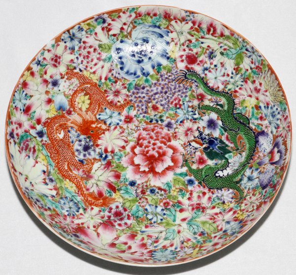 CHINESE ENAMELED PORCELAIN DRAGON BOWL: CHINESE ENAMELED PORCELAIN DRAGON BOWL, H 2", DIA 10 1/2":Enameled at the well with an orange and green dragon among flowers; signed underneath in blue with Qianlong mark (see additional photo).