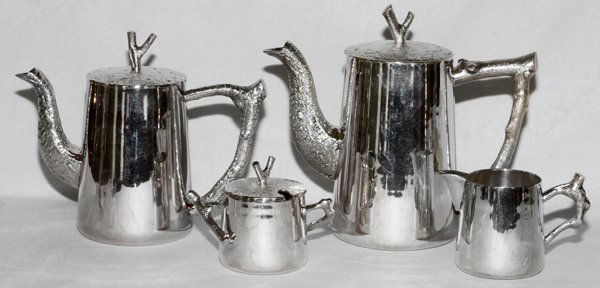 MICHAEL ARAM SILVERPLATE TEA & COFFEE SET: MICHAEL ARAM SILVERPLATE TEA & COFFEE SET, 1994, FOUR PIECES:Service includes one tea pot at H. 6 1/4", one coffee pot at H. 7 1/2", one covered sugar, and one creamer. All with branch form handles an