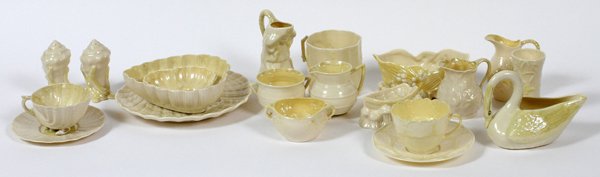 BELLEEK PORCELAIN CUPS SAUCERS CREAMERS SHELL PLATE: BELLEEK PORCELAIN CUPS, SAUCERS, CREAMERS, SHELL PLATE, ETC 20 PCS.:includes two cups (one having shell form feet), two saucers, five creamers, 3" - 4 1/2" H., two sugars, 2 & 2 1/4" H, one salt and o